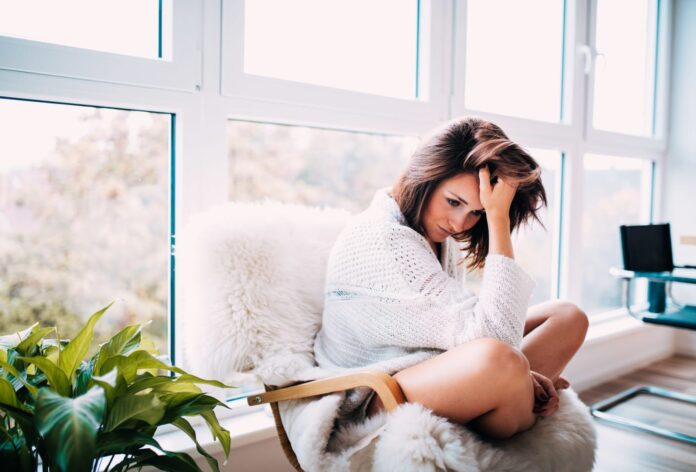 106442098-1584115438805portrait-sitting-women-girl-home-young-flat-apartment-sad-living-brunette-serious-feeling-stress_t20_1jarjn