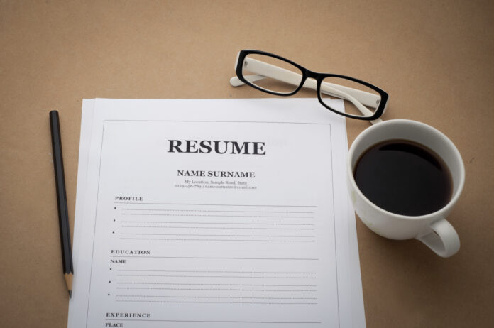 office desk with resume information, Coffee cup, black pencil an