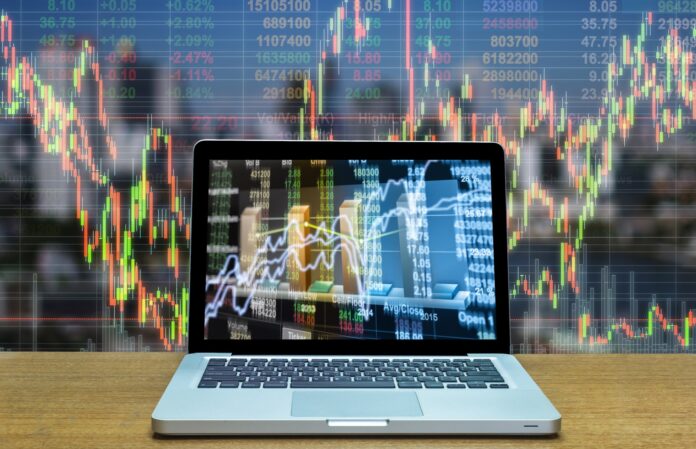 Stock exchange market trading graph over the screen of computer