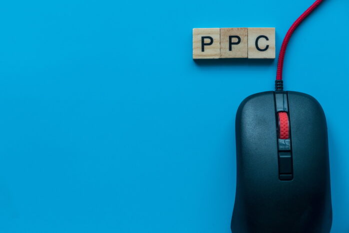PPC Pay Per Click with alphabet and mouse on blue background.