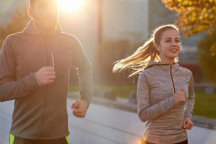 happy couple running outdoors