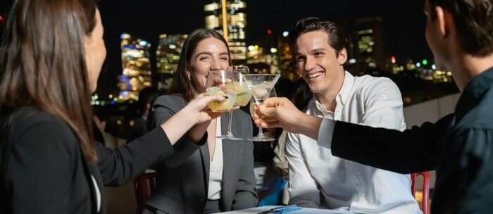 People clinking glasses on a Sydney harbour dinner cruise