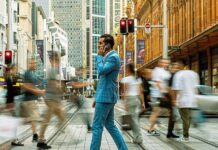 Sydney In One Day: Top Things To Do For Business Travellers A business man, with phone in hand, crossing the streets of Sydney