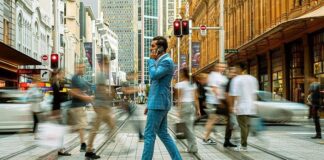 Sydney In One Day: Top Things To Do For Business Travellers A business man, with phone in hand, crossing the streets of Sydney